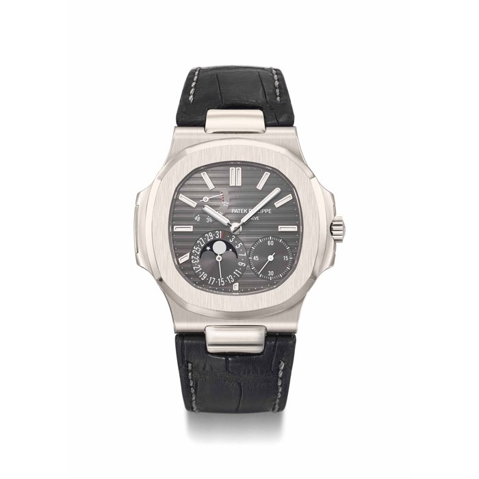 Patek Philippe. A fine and large 18K white gold automatic wristwatch with date, moon phases, power reserve, original certificate and box Signed Patek Philippe, Genève, Nautilus model, ref. 5712, movement no. 3'171'832, case no. 4'381'010, manufactured in 2007