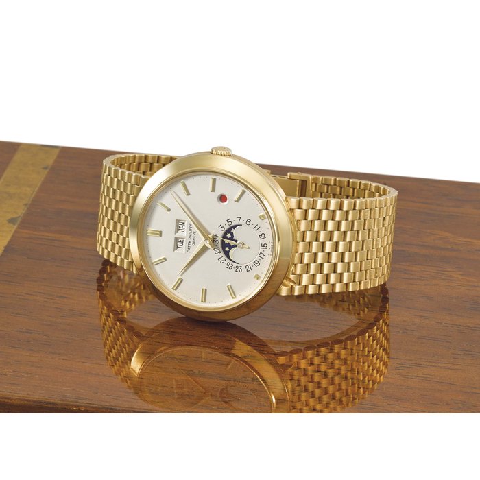 Patek Philippe. A very fine and rare 18K gold automatic perpetual calendar wristwatch with moon phases, "red dot" leap year indicator and integral bracelet Signed Patek Philippe, Genève, ref. 3450/1, movement no. 1’119’599, case no. 2’788’627, manufactured in 1981