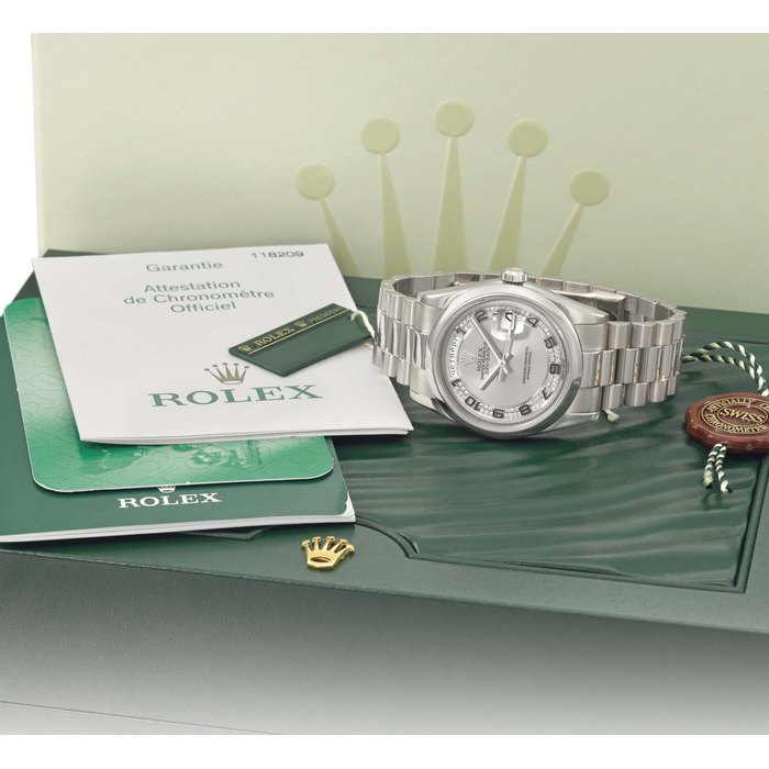 Rolex. A fine, rare and extremely attractive 18K white gold automatic wristwatch with Russian day indication, date, sweep centre seconds, diamond-set dial, bracelet, certificate and box Signed Rolex, Oyster Perpetual, Day-Date, Ref. 118209, Case No. Z303554, manufactured in 2006