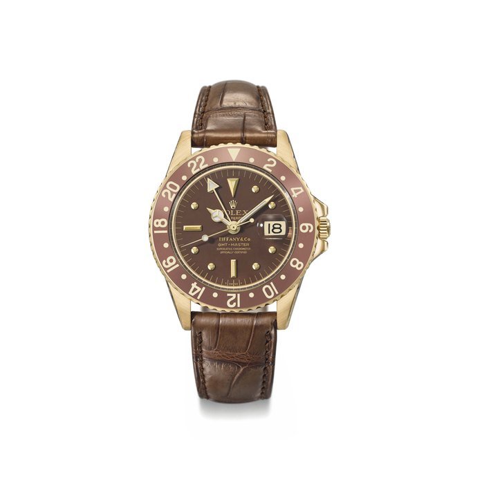 Rolex Rolex. A fine and very rare, 18K gold automatic two time-zone wristwatch with sweep centre seconds, brown nipple dial, 24 hour bezel and date Signed Rolex, retailed by Tiffany & Co., Oyster Perpetual, GMT-Master, Superlative Chronometer Officially Certified, ref. 1675, case no. 2’681’587, circa 1971 · 1675