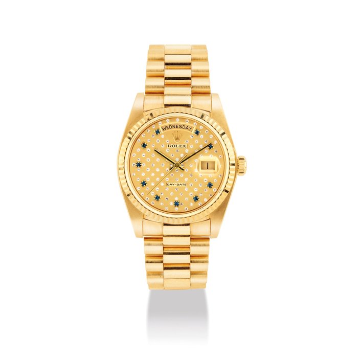 ROLEX. A FINE, RARE AND UNUSUAL 18K GOLD, DIAMOND AND SAPPHIRE SET AUTOMATIC WRISTWATCH WITH SWEEP CENTRE SECONDS, DAY, AND BRACELET SIGNED ROLEX, DAY-DATE, REF. 18038, CASE NO.7’645’079, CIRCA 1985
