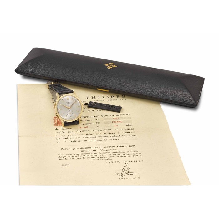 Patek Philippe. An extremely fine and very rare 18K gold dual time zone wristwatch with separately adjustable hour hand, Certificate of Origin, envelope, sales tag and box Signed Patek Philippe, Genève, ref. 2597, first series model, movement no. 729'446, case no. 311'323, manufactured in 1962