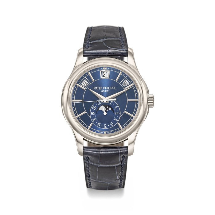 Patek Philippe. A very fine and rare limited edition 18K white gold automatic annual calendar wristwatch with 24 hour indication, sweep centre seconds, moon phases, original certificate and box, made for the 5th anniversary of the Patek Philippe boutique in Zurich Signed Patek Philippe, Genève, Ref. 5205G-011, Movement No. 5’987’689, Case No. 6’146’889, Manufactured in 2016