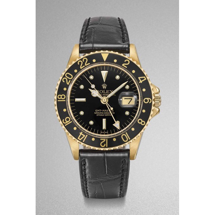 Rolex Rolex. A fine 18K gold automatic two time-zone time wristwatch with sweep centre seconds, black nipple dial, 24 hour bezel, date, service Guarantee and box Signed Rolex, Oyster Perpetual, GMT-Master, Superlative Chronometer Officially Certified, ref. 1675/8, case no. 2’402’810, circa 1970 · 1675/8