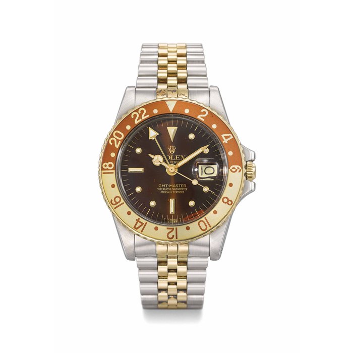 ROLEX. A FINE STAINLESS STEEL AND 18K GOLD AUTOMATIC DUAL TIME WRISTWATCH WITH SWEEP CENTRE SECONDS, DATE, BROWN DIAL, STAINLESS STEEL AND 14K BRACELET, ORIGINAL GUARANTEE AND BOX SIGNED ROLEX, OYSTER PERPETUAL, GMT-MASTER, REF. 1675, CASE NO. 5’204’548, CIRCA 1977