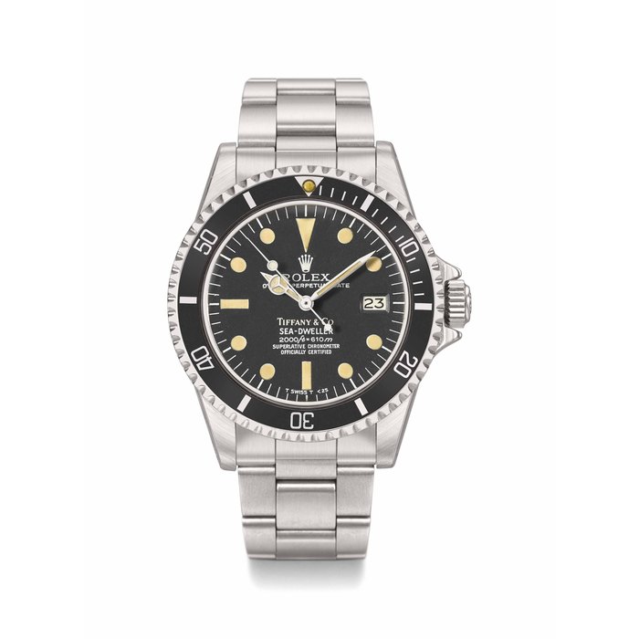 Rolex. A fine and rare stainless steel automatic wristwatch with sweep centre seconds, date, gas escape valve and bracelet Signed Rolex, Retailed by Tiffany & Co., Oyster Perpetual Date, Sea-Dweller, 2000ft=610M, Superlative Chronometer Officially Certified, Ref. 1665, Case No. 5’746’254, Circa 1979