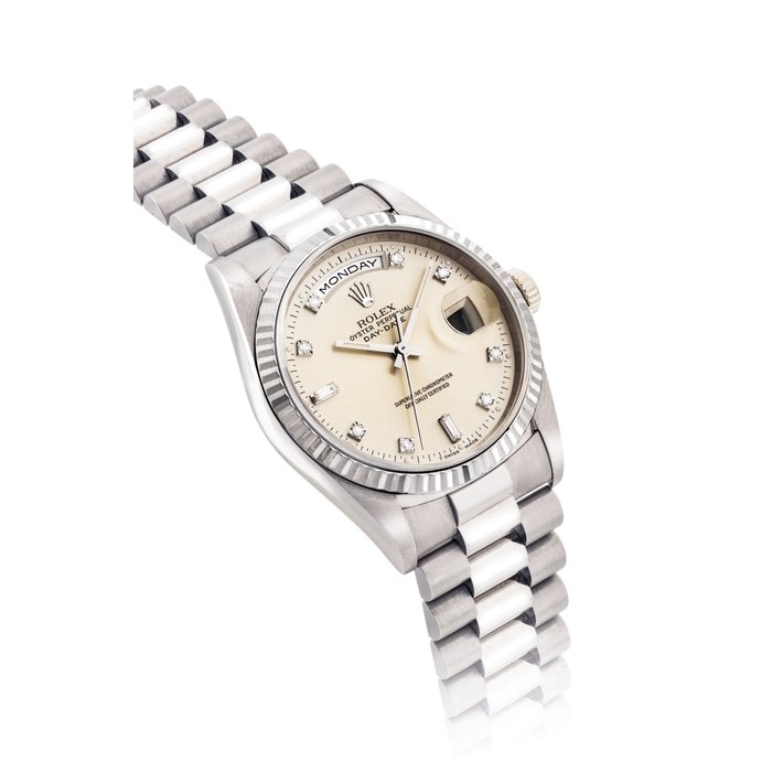 Rolex ROLEX. A FINE 18K WHITE GOLD AND DIAMOND-SET AUTOMATIC WRISTWATCH WITH SWEEP CENTRE SECONDS, DAY, DATE AND BRACELET SIGNED ROLEX, OYSTER PERPETUAL, DAY-DATE MODEL, REF. 18239, CASE NO. E560284, CIRCA 1990, Price & Market Data