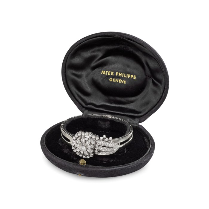 Patek Philippe. A lady's extremely fine 18K white gold watch with retailer-made diamond-set hinged cover and bracelet watch, box Signed Patek Philippe, Geneve, retailed by Hausmann & Co., Rome, ref. 3215, movement no. 948'645, case no. 692'056, movement, dial and case manufactured in 1957
