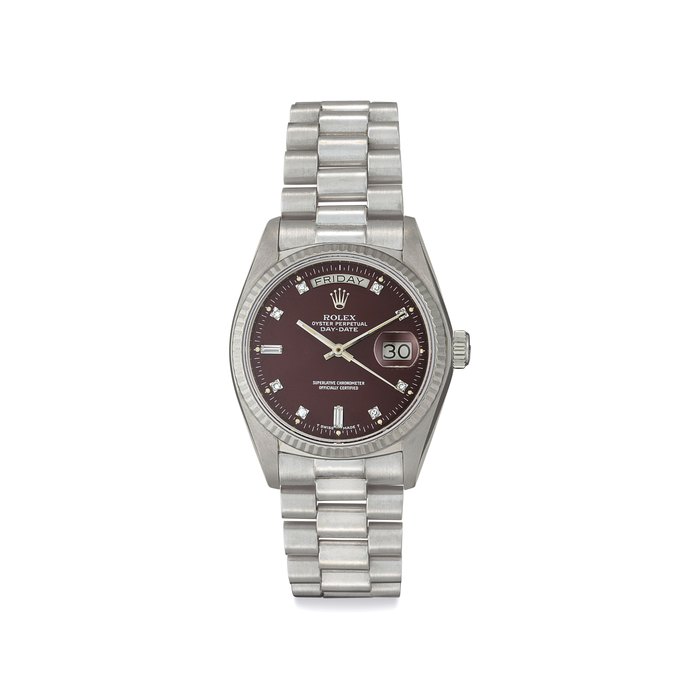 Rolex. A Very Fine and Attractive 18k White Gold and Diamond-set Automatic Wristwatch with Day, Date, Center Seconds, Oxblood "Stella" Dial and Bracelet Signed Rolex, Oyster Perpetual, Day-Date, Ref. 18039, Case No. 5'507'425, Circa 1978