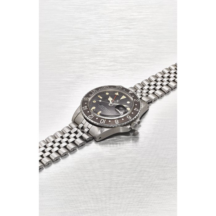 ROLEX. A STAINLESS STEEL AUTOMATIC DUAL TIME WRISTWATCH WITH SWEEP CENTRE SECONDS, DATE, BRACELET, "LONG E" AND TROPICAL DIAL SIGNED ROLEX, OYSTER PERPETUAL GMT-MASTER MODEL, REF. 1675, MOVEMENT NO. D016038, CASE NO. 2’944’164, CIRCA 1971