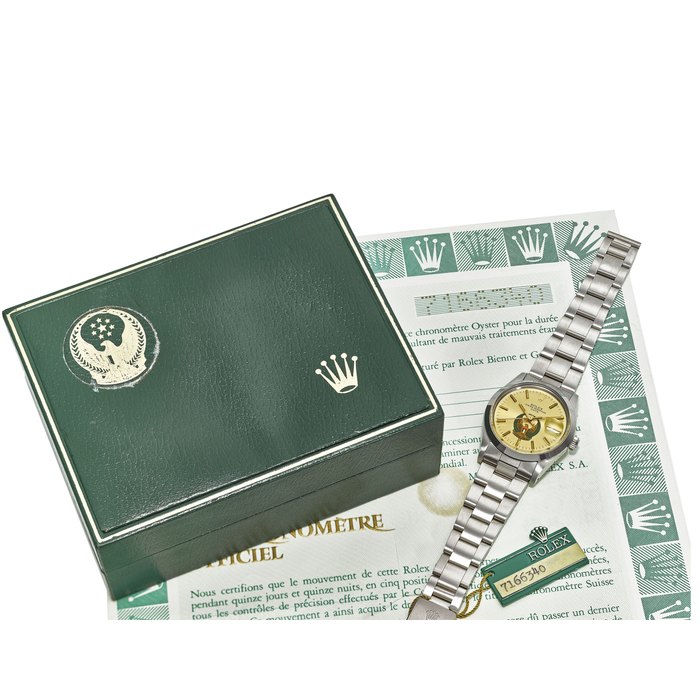 ROLEX. A VERY FINE AND RARE STAINLESS STEE L AUTOMATIC WRISTWATCH WITH UAE LOGO, ORIGINAL WARRANTY AND BOX SIGNED ROLEX, GENEVE, OYSTER PERPETUAL DATE, REF. 15000, CASE NO. 7’166’340, MOVEMENT NO. 0790376, CIRCA 1981