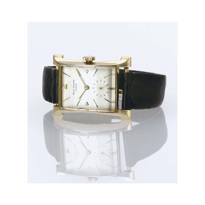 PATEK PHILIPPE. A RARE 18K GOLD RECTANGULAR WRISTWATCH WITH FLARED SIDES SIGNED PATEK PHILIPPE & CO., "EIFFEL TOWER", MOVEMENT NO. 970907, CASE NO. 653873, REF. 2441, MANUFACTURED IN 1948