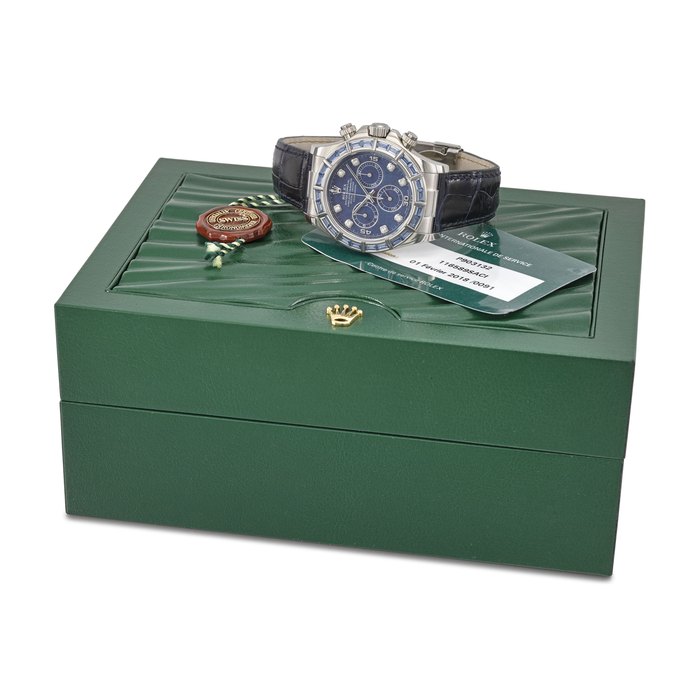 ROLEX. AN EXTREMLY RARE AND HIGHLY ATTRACTIVE 18K WHITE GOLD AND SAPPHIRE-SET AUTOMATIC CHRONOGRAPH WRISTWATCH WITH DIAMOND-SET SODALITE DIAL, SERVICE GUARANTEE AND BOX SIGNED ROLEX, OYSTER PERPETUAL, CHRONOGRAPH, DAYTONA, REF. 116589SACI, CASE NO. P903132, CIRCA 2000