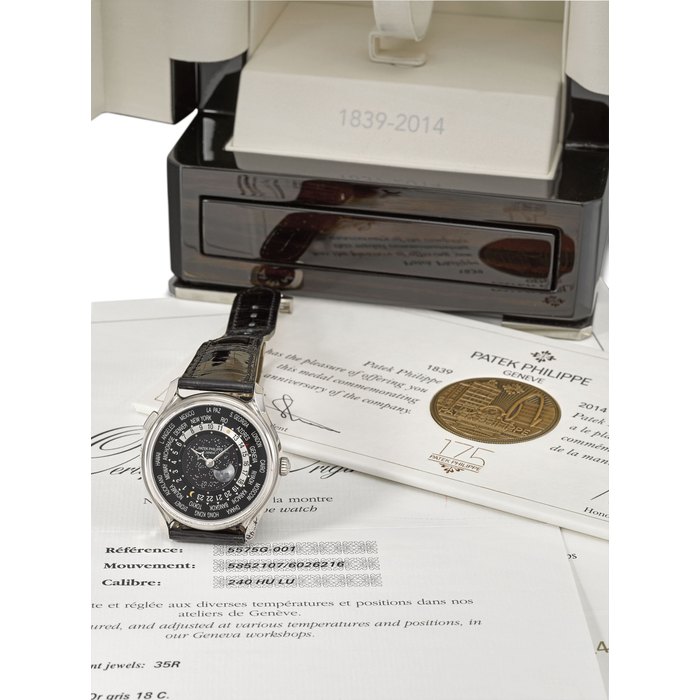 PATEK PHILIPPE. AN ATTRACTIVE AND RARE 18K WHITE GOLD LIMITED EDITION AUTOMATIC WORLD TIME WRISTWATCH WITH MOON PHASES, ORGINAL CERTIFICATE, ATTESTATION, COMMEMORATIVE MEDAL, AND BOX MADE TO COMMEMORATE THE PATEK PHILIPPE 175TH ANNIVERSARY OF PATEK PHILIPPE IN 2014 Signed Patek Philippe, Genève, 175th anniversary 1839-2014, World Time Moon, ref. 5575G-001, movement no. 5’852’107, case no. 6’026’216, circa 2014