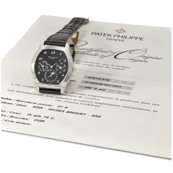 Patek Philippe. An extremely fine and very rare 18K white gold automatic tonneau-shaped perpetual calendar wristwatch with moon phases, black dial, Breguet numerals and original certificate Signed Patek Philippe, Geneve, ref. 5041G, movement no. 3'124'476, case no. 4'027'501, circa 2000