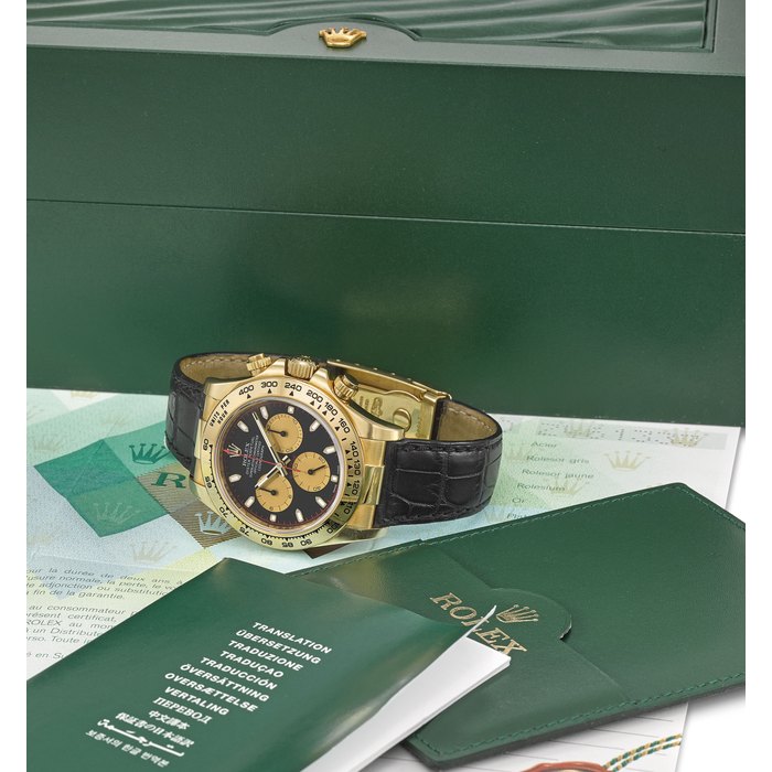 ROLEX. A VERY FINE AND RARE 18K GOLD AUTOMATIC CHRONOGRAPH WRISTWATCH WITH ORIGINAL GUARANTEE AND BOX SIGNED ROLEX, OYSTER PERPETUAL, COSMOGRAPH, DAYTONA, REF. 116518, CASE NO. Z461333, CIRCA 2007