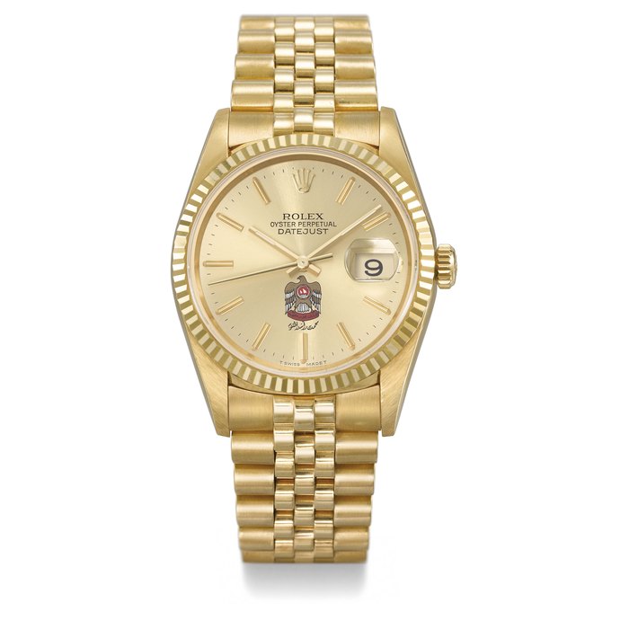 ROLEX. A VERY RARE 18K GOLD AUTOMATIC WRISTWATCH WITH SWEEP CENTRE SECONDS, DAY, DATE, CHAMPAGNE DIAL WITH THE UAE DESERT EAGLE COAT OF ARMS AND BRACELET, MADE FOR HIS HIGHNESS SHEIKH MOHAMMED BIN RASHID AL MAKTOUM SIGNED ROLEX, OYSTER PERPETUAL, DATEJUST, REF. 16238, CASE NO. T785255, CIRCA 1996