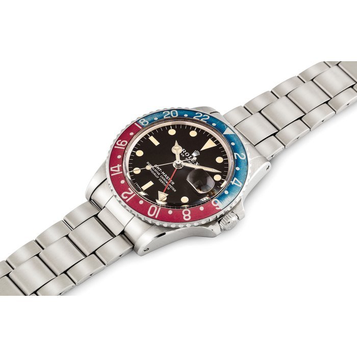 Rolex ROLEX. A FINE AND RARE STAINLESS STEEL AUTOMATIC DUAL TIME WRISTWATCH WITH SWEEP CENTRE SECONDS, DATE AND BRACELET SIGNED ROLEX, OYSTER PERPETUAL, GMT-MASTER MODEL, REF. 1675, CASE NO. 3'161'985, CIRCA 1972 · 1675