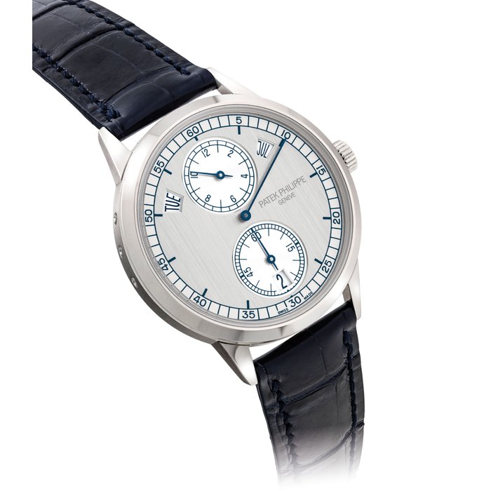 PATEK PHILIPPE. A FINE 18K WHITE GOLD AUTOMATIC ANNUAL CALENDAR WRISTWATCH WITH REGULATOR-STYLE DIAL SIGNED PATEK PHILIPPE, REF. 5235, MOVEMENT NO. 5'727'739, CASE NO. 4'690'642, CIRCA 2014