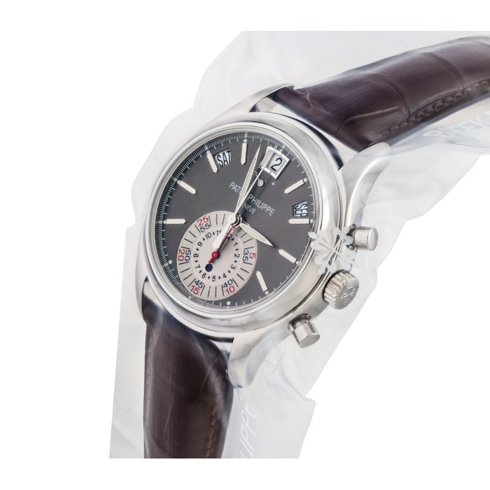 PATEK PHILIPPE. A VERY FINE PLATINUM AUTOMATIC ANNUAL CALENDAR FLYBACK CHRONOGRAPH WRISTWATCH WITH DAY AND NIGHT INDICATION POWER RESERVE SIGNED PATEK PHILIPPE, REF. 5960, MOVEMENT NO. 3'503'943, CASE NO. 4'464'044, CIRCA 2009