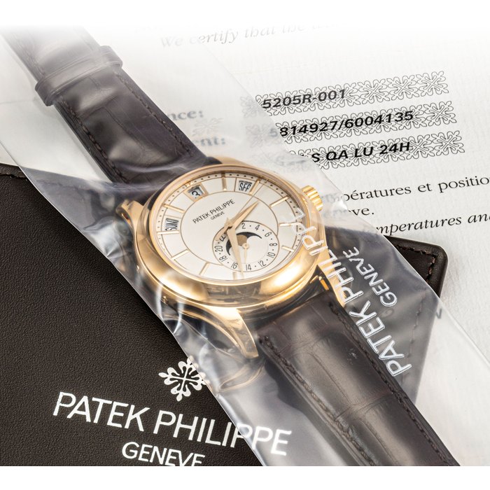 PATEK PHILIPPE. A FINE 18K PINK GOLD AUTOMATIC ANNUAL CALENDAR WRISTWATCH WITH SWEEP CENTRE SECONDS, MOON PHASES AND 24 HOUR INDICATION SIGNED PATEK PHILIPPE, REF. 5205, MOVEMENT NO. 5'814'927, CASE NO. 6'004'135, CIRCA 2014
