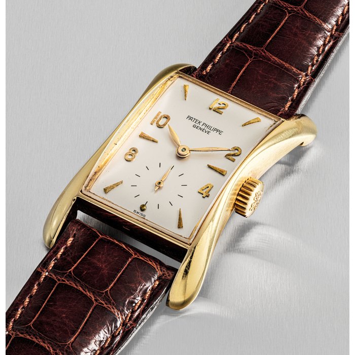 Patek Philippe PATEK PHILIPPE. A FINE AND RARE 18K GOLD RECTANGULAR WRISTWATCH WITH FLARED SIDES SIGNED PATEK PHILIPPE, GENEVE, REF. 2442, MOVEMENT NO. 975'582, CASE NO. 676'821, MANUFACTURED IN 1953, Price & Market Data