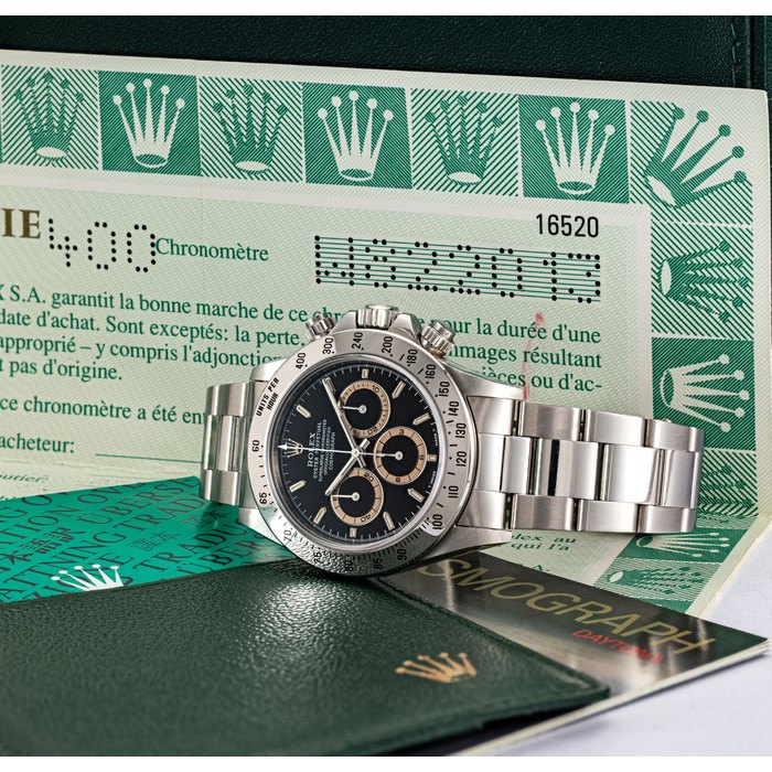Rolex ROLEX. A FINE AND ATTRACTIVE STAINLESS STEEL AUTOMATIC CHRONOGRAPH WRISTWATCH WITH BRACELET AND "TROPICAL BROWN" CHAPTER RINGS SIGNED ROLEX, OYSTER PERPETUAL, COSMOGRAPH DAYTONA MODEL, REF. 16520, CASE NO. W822013, CIRCA 1995, Price & Market Data