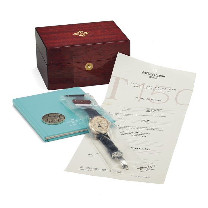 Patek Philippe. A Very Rare 18k White Gold Limited Edition Automatic Annual Calendar Wristwatch with Moon Phases and Center Seconds, Factory Sealed Signed Patek Philippe, Genève, Retailed by Tiffany & Co., Ref. 5150G, Movement No. 3'235'313, Case No. 4'171'787, Manufactured in 2002