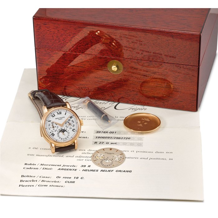 Patek Philippe. An extremely fine, rare and important 18K pink gold automatic minute repeating perpetual calendar wristwatch with phases of the moon, additional white Roman dial, regular dial, case back, original certificate and box Signed Patek Philippe, Genève, ref. 3974R, movement no. 1'906'091, case no. 2'962'726, movement manufactured in 1994, encased and sold in 2000