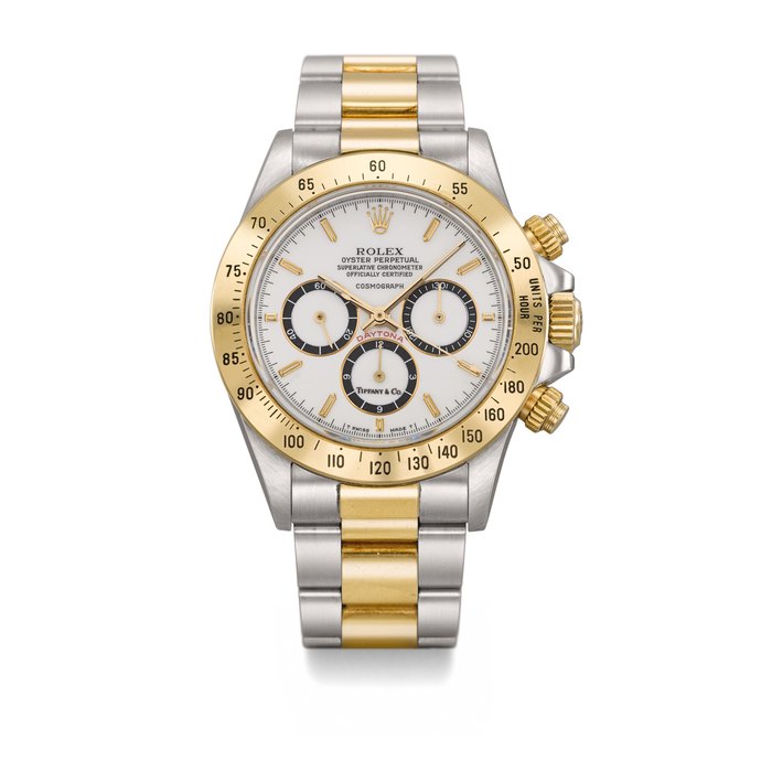 ROLEX. AN EXTREMELY RARE STAINLESS STEEL AND GOLD AUTOMATIC CHRONOGRAPH WRISTWATCH WITH PORCELAIN “FLOATING COSMOGRAPH” DIAL, BRACELET AND CONFIRMATION LETTER Signed Rolex, Oyster Perpetual, Cosmograph, Daytona Model, Retailed by Tiffany & Co., Ref. 16523, Case No. R985495, Circa 1988