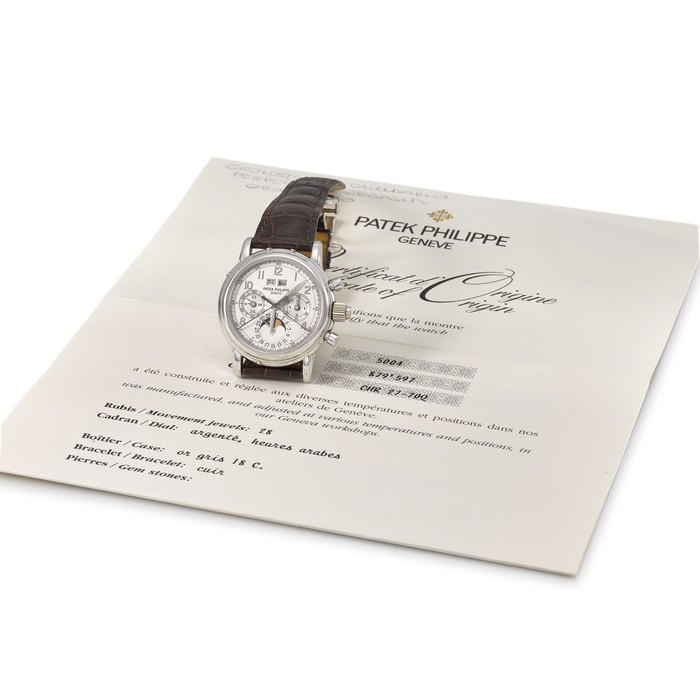 Patek Philippe. A very fine and rare 18K white gold perpetual calendar split seconds chronograph wristwatch with moon phases, 24 hour and leap year indication, additional case back and original certificate Signed Patek Philippe, Genève, ref. 5004G, movement no. 897’597, case no. 2’997’120, manufactured in 1996