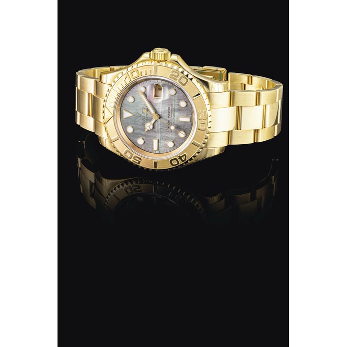 ROLEX. AN 18K GOLD AUTOMATIC WRISTWATCH WITH SWEEP CENTRE SECONDS, DATE, BRACELET AND MOTHER-OF-PEARL DIAL SIGNED ROLEX, OYSTER PERPETUAL, YACHT MASTER MODEL, REF. 16628B, CASE NO. Y172836, CIRCA 2002