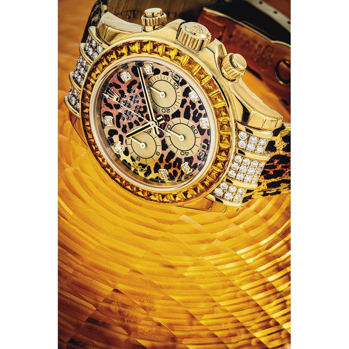 ROLEX. AN ATTRACTIVE 18K GOLD, DIAMOND AND YELLOW SAPPHIRE-SET AUTOMATIC CHRONOGRAPH WRISTWATCH WITH LEOPARD-PRINT DIAL SIGNED ROLEX, OYSTER PERPETUAL, DAYTONA MODEL, REF. 116598SACO, CASE NO. K595022, CIRCA 2001