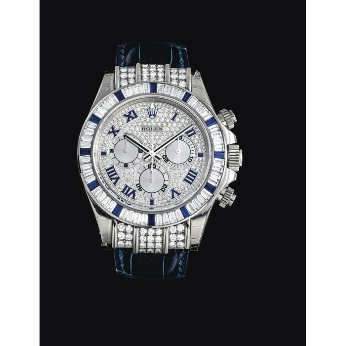 ROLEX. A RARE AND IMPRESSIVE 18K WHITE GOLD, DIAMOND AND SAPPHIRE-SET AUTOMATIC CHRONOGRAPH WRISTWATCH SIGNED ROLEX, DAYTONA MODEL, REF. 116599 SA, CASE NO. K590616, CIRCA 2005