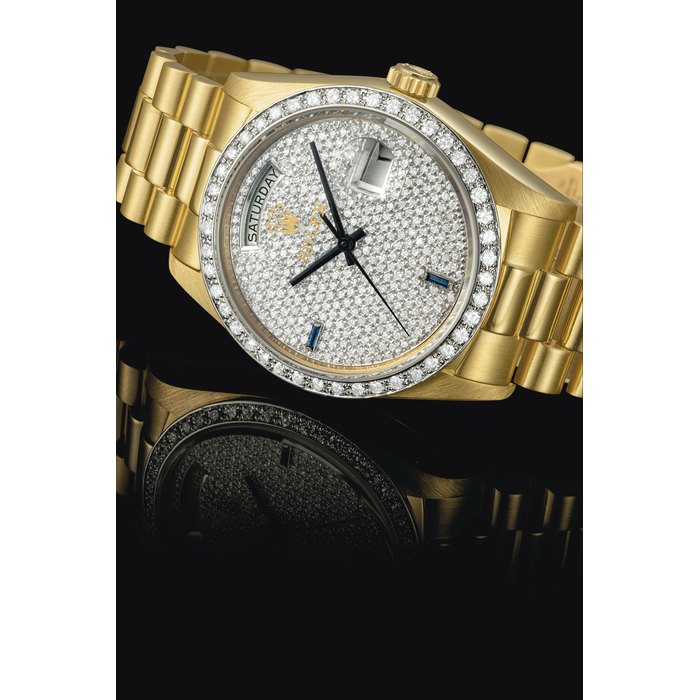 Rolex ROLEX. A RARE AND ATTRACTIVE 18K GOLD, DIAMOND AND SAPPHIRE-SET AUTOMATIC WRISTWATCH WITH SWEEP CENTRE SECONDS, DAY, DATE AND BRACELET SIGNED ROLEX, DAY-DATE MODEL, REF. 18048, CASE NO. 5'724'505, CIRCA 1978, Price & Market Data