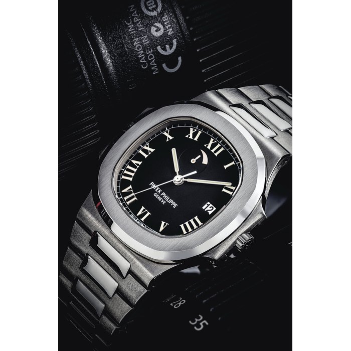 PATEK PHILIPPE. A STAINLESS STEEL AUTOMATIC WRISTWATCH WITH SWEEP CENTRE SECONDS, DATE, POWER RESERVE AND BRACELET SIGNED PATEK PHILIPPE, GENEVE, NAUTILUS MODEL, REF. 3710, MOVEMENT NO. 3'148'160, CASE NO. 4'050'538, MANUFACTURED IN 1998