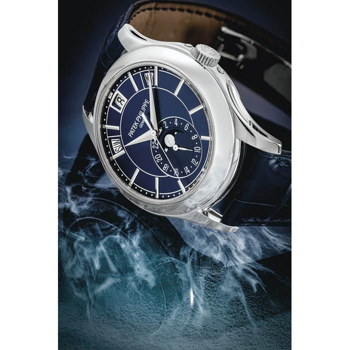 PATEK PHILIPPE. A VERY RARE 18K WHITE GOLD LIMITED EDITION AUTOMATIC ANNUAL CALENDAR WRISTWATCH WITH SWEEP CENTRE SECONDS, MOON PHASES AND BLUE DIAL, MADE FOR THE 5TH ANNIVERSARY OF THE PATEK PHILIPPE BOUTIQUE AT BEYER IN ZURICH SIGNED PATEK PHILIPPE, GENEVE, REF. 5205, MOVEMENT NO. 5’987’689, CASE NO. 6’146’889, MANUFACTURED IN 2016