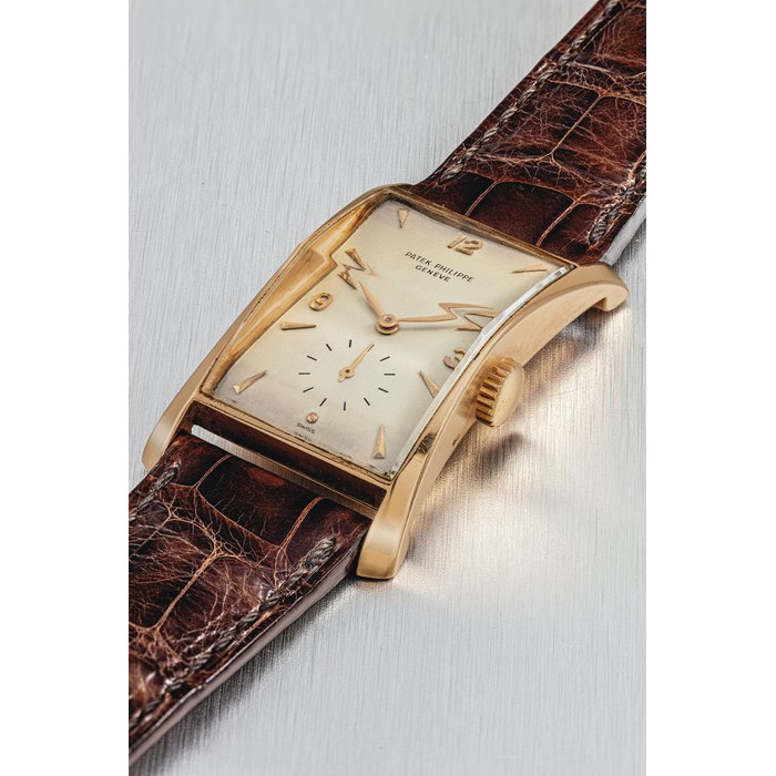 PATEK PHILIPPE. A VERY FINE AND RARE 18K PINK GOLD RECTANGULAR CURVED WRISTWATCH SIGNED PATEK PHILIPPE, GENEVE, REF. 1593, MOVEMENT NO. 970’599, CASE NO. 652’785, MANUFACTURED IN 1948