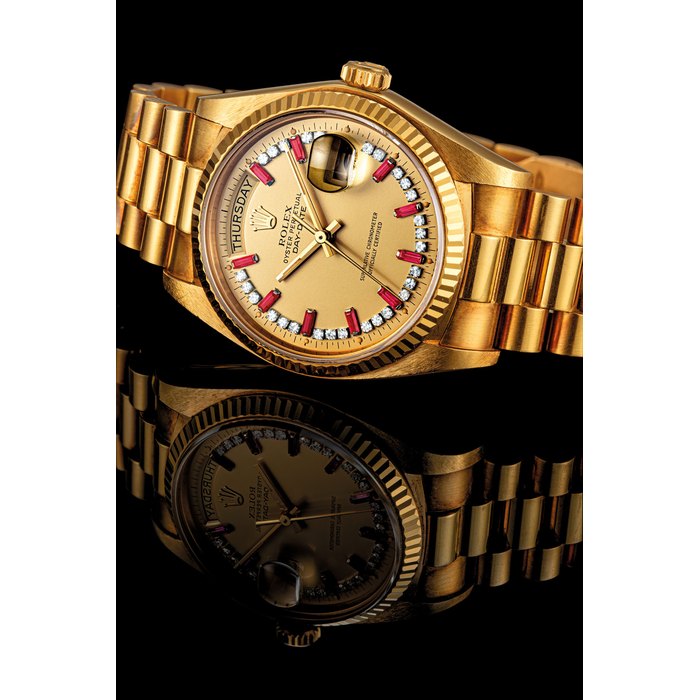 ROLEX. AN 18K GOLD, DIAMOND AND RUBY-SET AUTOMATIC WRISTWATCH SWEEP CENTRE SECONDS, DAY, DATE AND BRACELET DAY-DATE MODEL, REF. 18038, CIRCA 1980