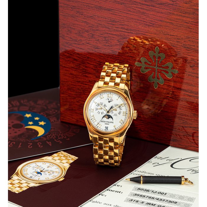 PATEK PHILIPPE. AN 18K GOLD AUTOMATIC ANNUAL CALENDAR WRISTWATCH WITH SWEEP CENTRE SECONDS, POWER RESERVE, MOON PHASES AND BRACELET REF. 5036/1, CIRCA 2006