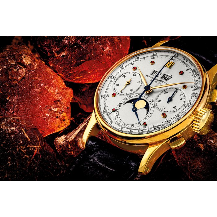 PATEK PHILIPPE. A HISTORICALLY VERY IMPORTANT 18K GOLD PERPETUAL CALENDAR CHRONOGRAPH WRISTWATCH WITH CHARLES STERN'S UNIQUE SPECIAL REQUEST DIAL WITH CABOCHON RUBY HOUR MARKERS AND 3-MINUTE PHONECALL COUNTDOWN FEATURE REF. 1518, MANUFACTURED IN 1945