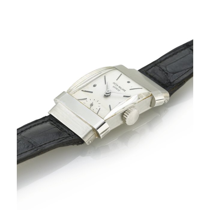 PATEK PHILIPPE. A FINE AND RARE PLATINUM RECTANGULAR WRISTWATCH WITH HOODED LUGS SIGNED PATEK PHILIPPE, GENEVE, MOVEMENT NO. 975507, CASE NO. 678687, REF. 1450, MANUFACTURED IN 1953