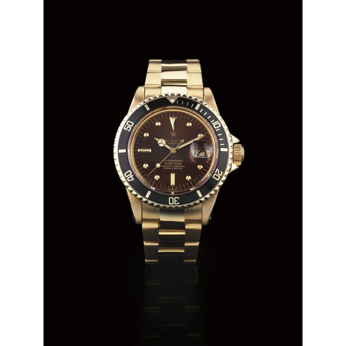 ROLEX. A FINE AND RARE 18K GOLD AUTOMATIC WATER-RESISTANT WRISTWATCH WITH CENTER SECONDS, DATE AND BROWN DIAL SIGNED ROLEX, OYSTER PERPETUAL DATE, "SUBMARINER", 660FT=200M, MOVEMENT NO. D281664, CASE NO. 4219216, REF. 1680, CIRCA 1975