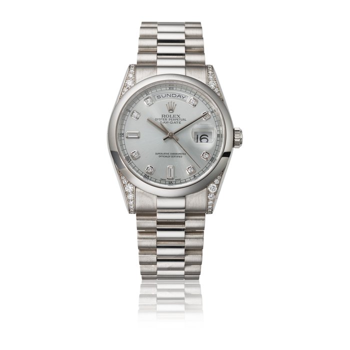 ROLEX. A RARE PLATINUM AND DIAMOND-SET AUTOMATIC WRISTWATCH WITH SWEEP CENTRE SECONDS, DAY, DATE, BRACELET, GUARANTEE AND BOX SIGNED ROLEX, DAY-DATE MODEL, REF. 118296, CASE NO. P194772, CIRCA 2000