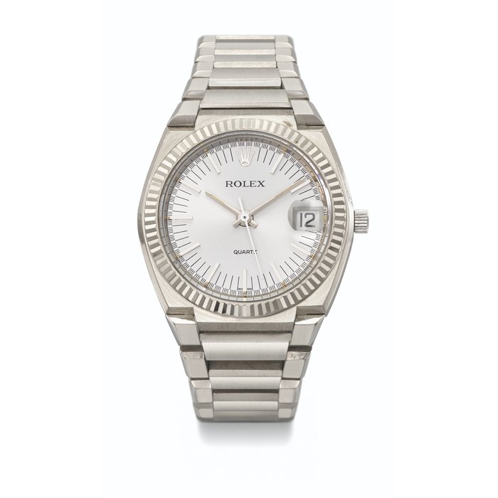 ROLEX. AN EXTREMELY RARE 18K WHITE GOLD TONNEAU-SHAPED WRISTWATCH WITH SWEEP CENTRE SECONDS, DATE AND BRACELET SIGNED ROLEX, QUARTZ, REF. 5100, MOVEMENT NO. 7308, CASE NO. 755, CIRCA 1973