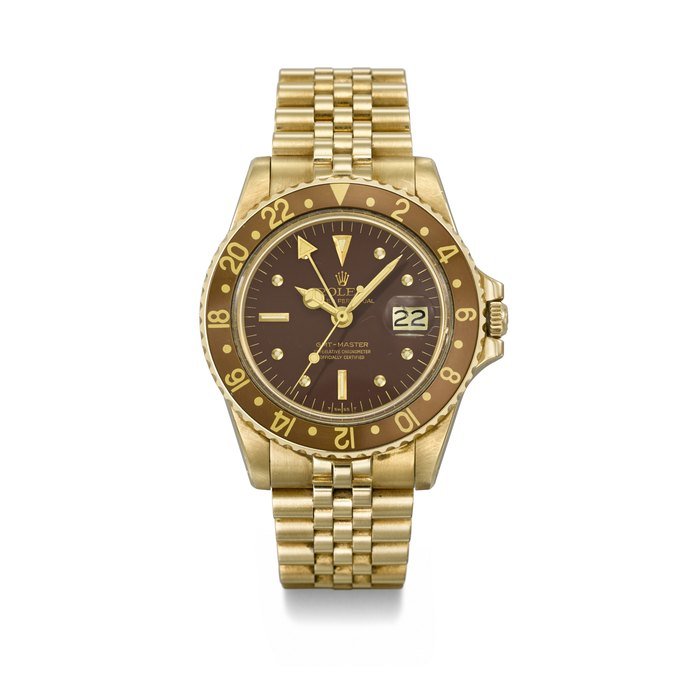 Rolex ROLEX. AN ATTRACTIVE 18K GOLD AUTOMATIC DUAL TIME WRISTWATCH WITH SWEEP CENTRE SECONDS, DATE, BRACELET AND BOX SIGNED ROLEX, GMT-MASTER MODEL, REF. 1675, CASE NO. 5'903'898, CIRCA 1979 · 1675