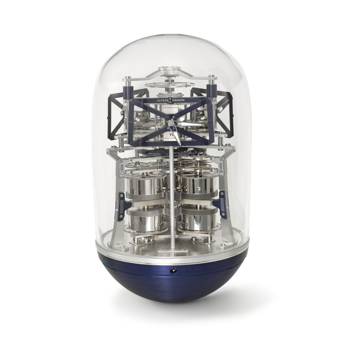 ULYSSE NARDIN. A RARE LIMITED EDITION ALUMINIUM AND BLOWN GLASS SCULPTURAL TRIPLE TIME ZONE TABLE CLOCK WITH ONE-YEAR POWER RESERVE, GUARANTEE AND BOX SIGNED ULYSSE NARDIN, UFO BLUE MODEL, NO. 50⁄75, CIRCA 2021