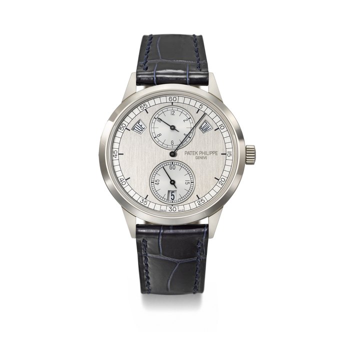 PATEK PHILIPPE. AN ATTRACTIVE 18K WHITE GOLD AUTOMATIC ANNUAL CALENDAR WRISTWATCH WITH REGULATOR-STYLE DIAL, CERTIFICATE OF ORIGIN AND BOX SIGNED PATEK PHILIPPE, GENEVE, REF. 5235G-001, CIRCA 2017