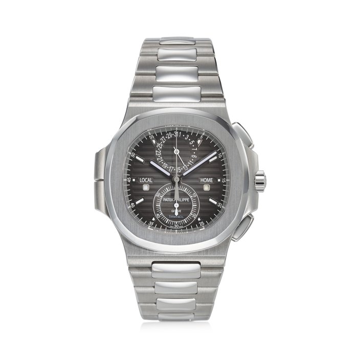 PATEK PHILIPPE, REF. 5990/1A-001, NAUTILUS, A VERY FINE AND RARE STEEL TRAVEL TIME FLYBACK CHRONOGRAPH BRACELET WATCH WITH DATE AND DAY/NIGHT INDICATORS, SIGNED AND RETAILED BY TIFFANY & CO.