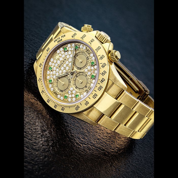 Rolex ROLEX. A RARE 18K GOLD, EMERALD AND DIAMOND-SET AUTOMATIC CHRONOGRAPH WRISTWATCH WITH BRACELET DAYTONA MODEL, REF. 16528, CIRCA 1995 · 16528